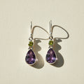 Silver-tone teardrop dangle earrings with green round and purple amethyst gems
