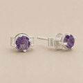 Silver prong-set amethyst stud earrings with purple oval gemstone and butterfly back