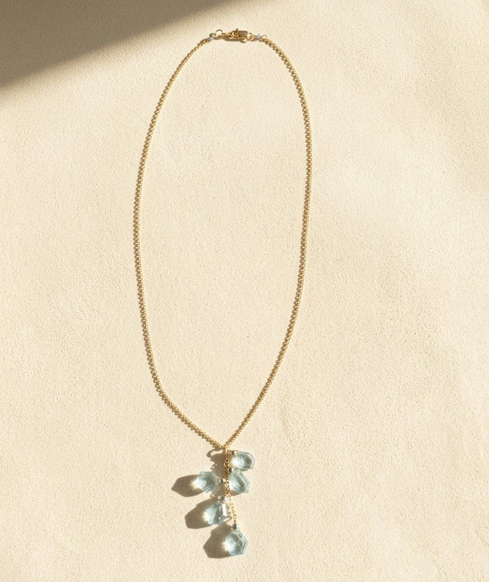 Aqua slice lariat necklace with long gold chain and teal faceted drop charm