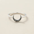 Silver ring with black crescent moon and round dot accents