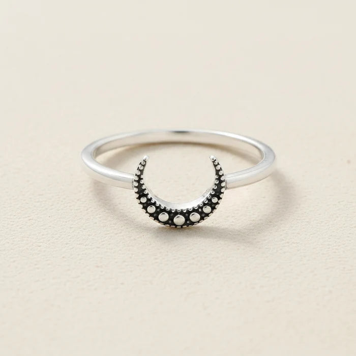 Silver ring with black crescent moon and round dot accents