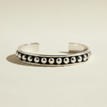 Silver-tone cuff bracelet with round black and white beaded row accents