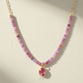 Beaded paperclip necklace with purple bead strand and pink teardrop charm