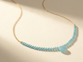 Beaded stones necklace with light blue faceted beads and small drop charm on gold chain