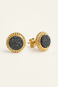 Gold earrings with black druzy stones on a white background