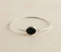 Sterling silver bangle bracelet with round black druzy stone centerpiece
