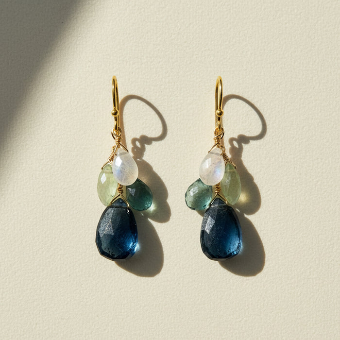 Cluster drop earrings with gold hooks and layered blue, green, and clear beads