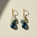 Cluster drop earrings with gold hooks and layered blue, green, and clear beads
