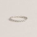 Silver braided ring on a light beige background