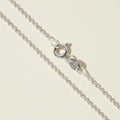 Silver cable chain necklace with circular clasp and oval logo charm