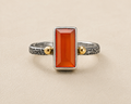 Carnelian orange stone ring with textured silver band and gold side accents