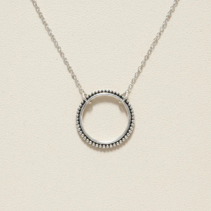 Silver circle pendant necklace with dotted round halo and link chain