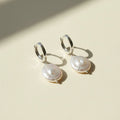 Pair of pearl earrings on a white background