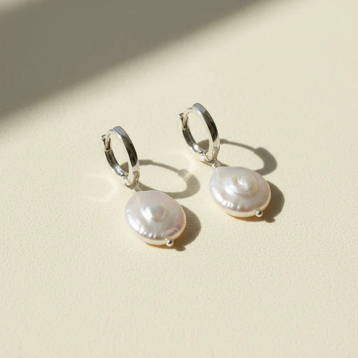 Pair of pearl earrings on a white background