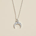 Silver-tone crescent moon necklace with star accents on a linked chain