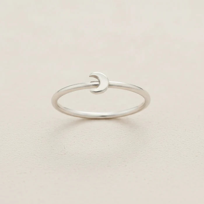 Silver crescent moon ring with smooth open band and small moon-shaped front detail
