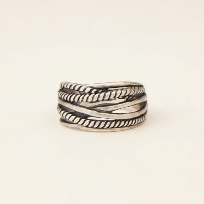 Silver ring with braided design on a white background