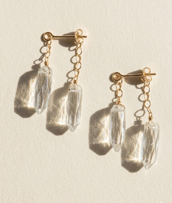 Gold-tone dagger crystal drop earrings with clear faceted prisms and chain links
