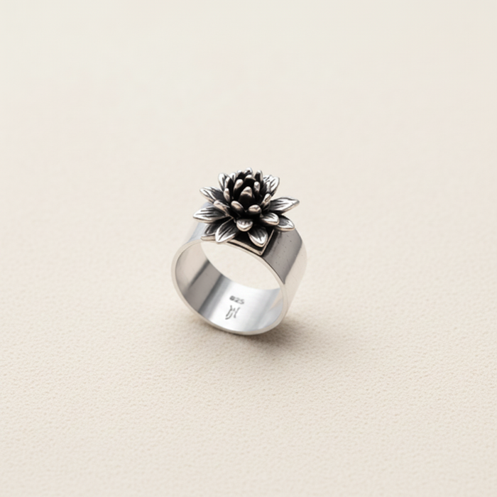 Adjustable silver ring with raised black flower cluster and small light center