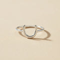 Silver horseshoe-shaped dainty ring with open U design on a slim band