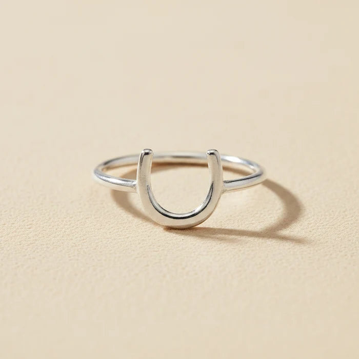 Silver horseshoe-shaped dainty ring with open U design on a slim band