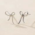 Small ribbon bow stud earrings in silver-tone metal with curved loops and tails