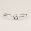 Silver cuff bracelet with double-knot chain centerpiece