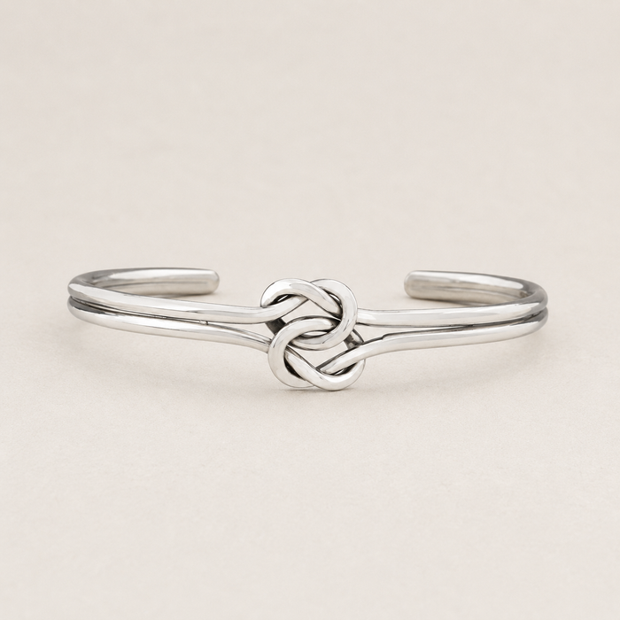 Silver cuff bracelet with double-knot chain centerpiece