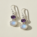 Double oval gemstone dangle earrings with purple top and iridescent white drops, silver-tone