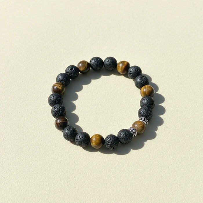 Beaded talisman bracelet with dark stone beads and brown-gold accent beads