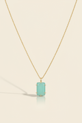 Aqua blue emerald-cut pendant necklace with gold-tone chain and bezel-set stone