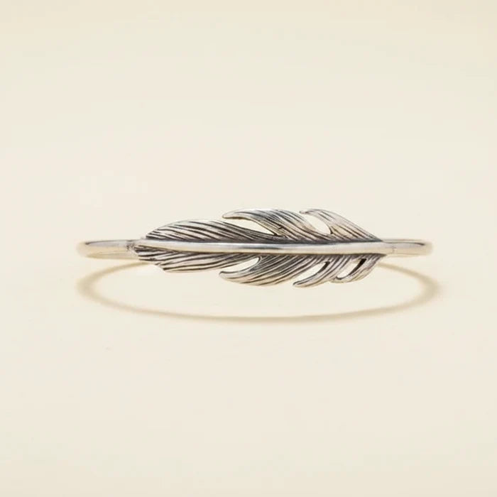 Silver feather-shaped bracelet on a white background
