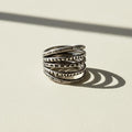 Sterling silver-tone stack ring with five textured bands and carved patterns