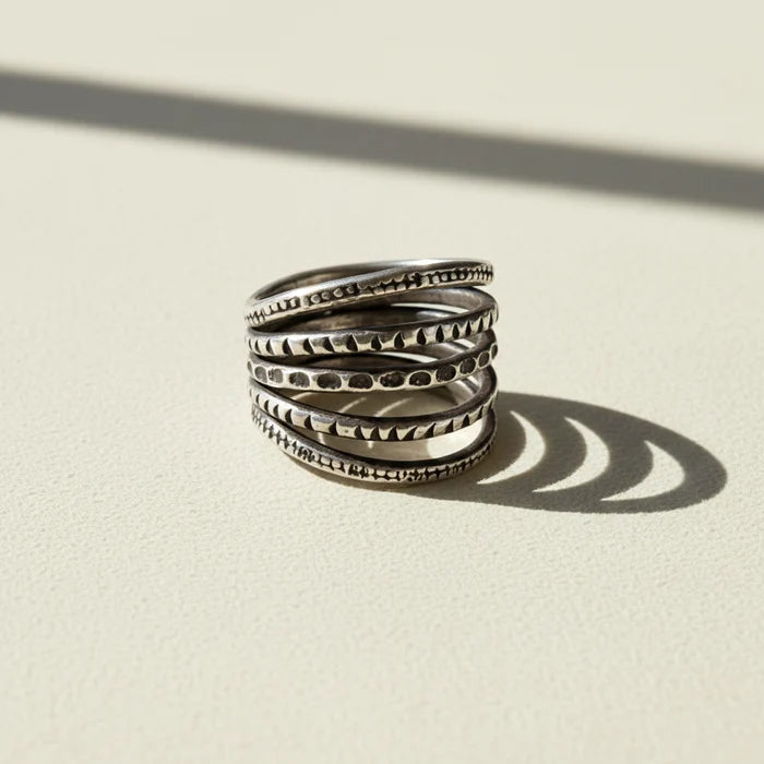 Sterling silver-tone stack ring with five textured bands and carved patterns