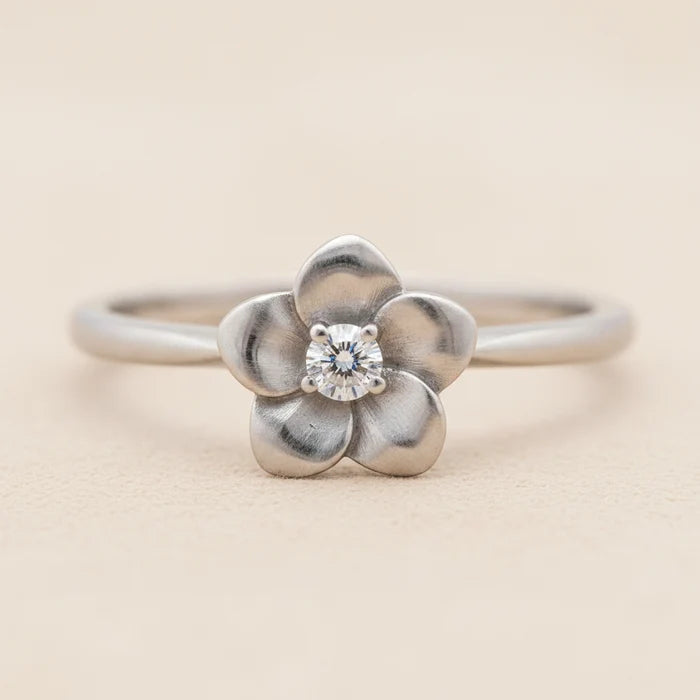 Flower ring with silver-tone band, four-petal flower and round crystal center