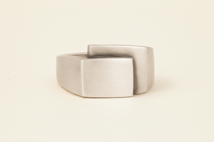Silver-gray fold-over deco ring with square center face and wide band