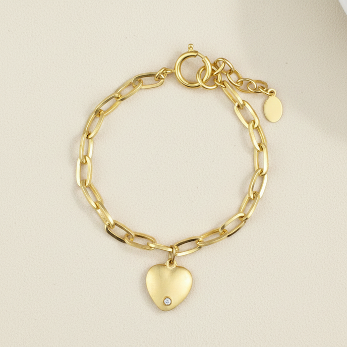 Gold-tone chain bracelet with heart charm and small round tag charm