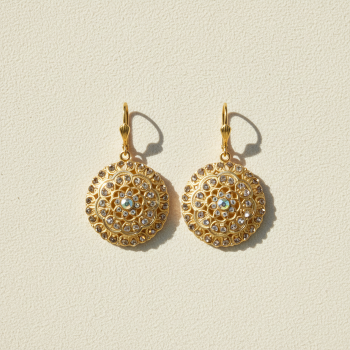 Gold-tone round dangle earrings with crystal border and blue center detail