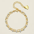 Gold-tone paperclip bracelet with white pearl beads and teardrop charm