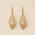 Gold-tone teardrop dangle earrings with filigree and clear faceted center
