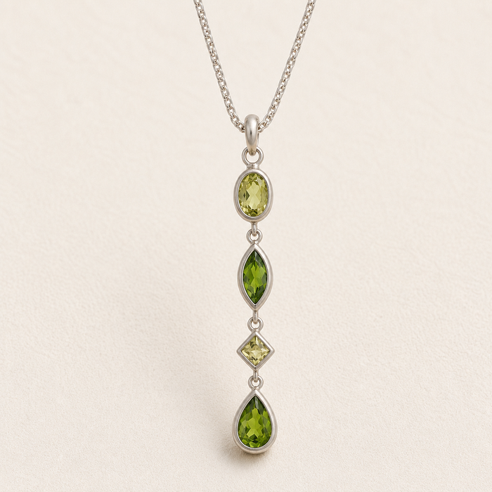 Gemstone drop necklace with four green faceted marquise pendants on silver chain