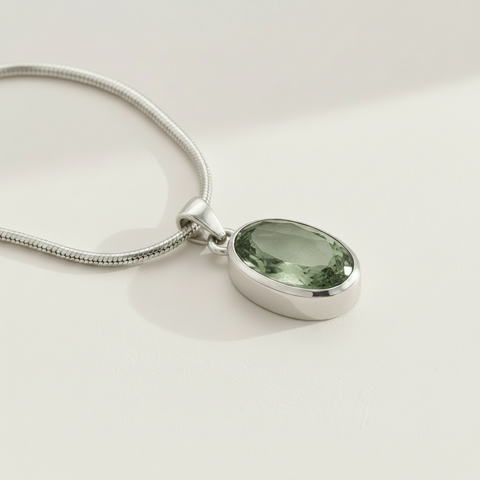 Silver snake chain pendant with oval green gemstone in bezel setting