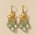 Gold-tone clover dangle earrings with green teardrop and amethyst-like bead accents