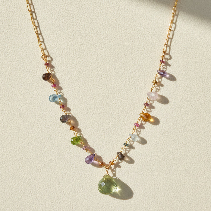 Gold-toned paperclip necklace with multicolor gemstone beads and green teardrop pendant