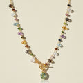 Gold-tone toggle necklace with multicolor beads and green oval pendant charm