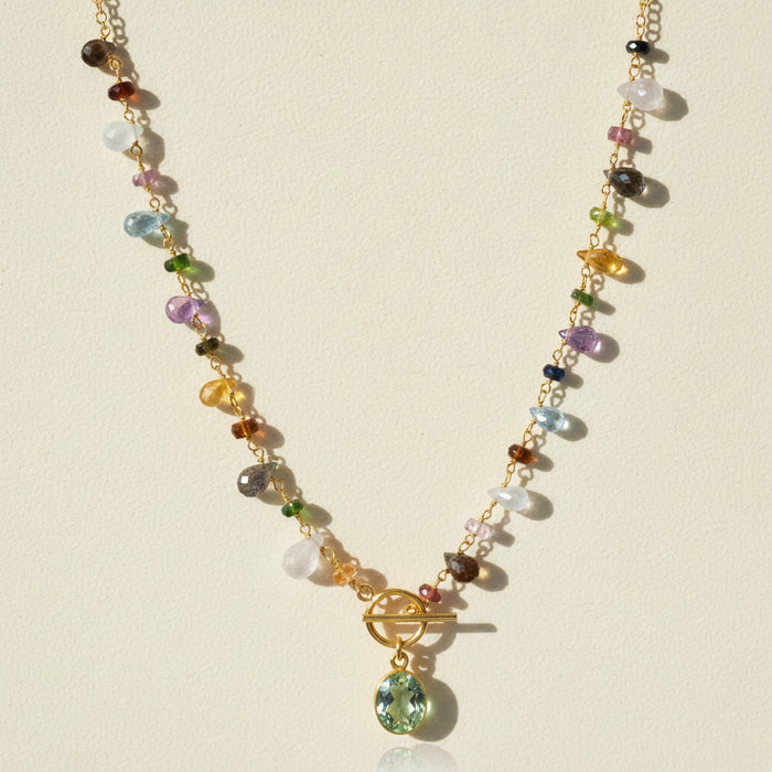 Gold-tone toggle necklace with multicolor beads and green oval pendant charm