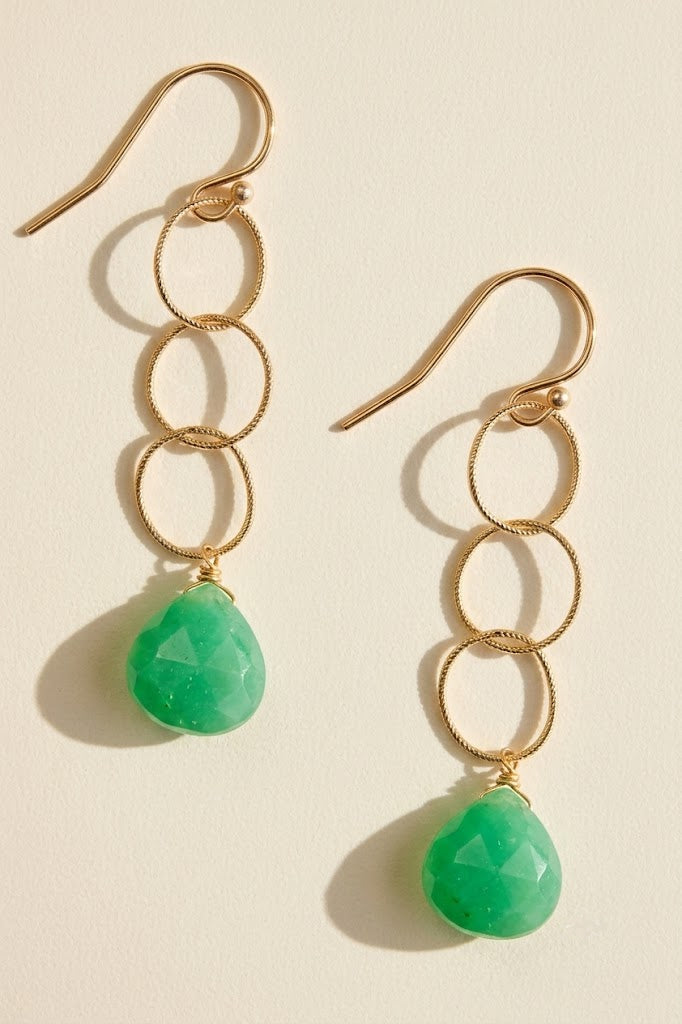 Gold-tone hoop drop earrings with three textured rings and green teardrop charms