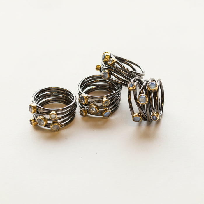 Gunmetal tone sterling statement ring set with stacked spiral bands and bezel-set stones