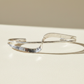 Silver hammered cuff bracelet with double wave design and open ends