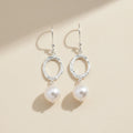 Silver hammered oval dangle earrings with white pearl drops